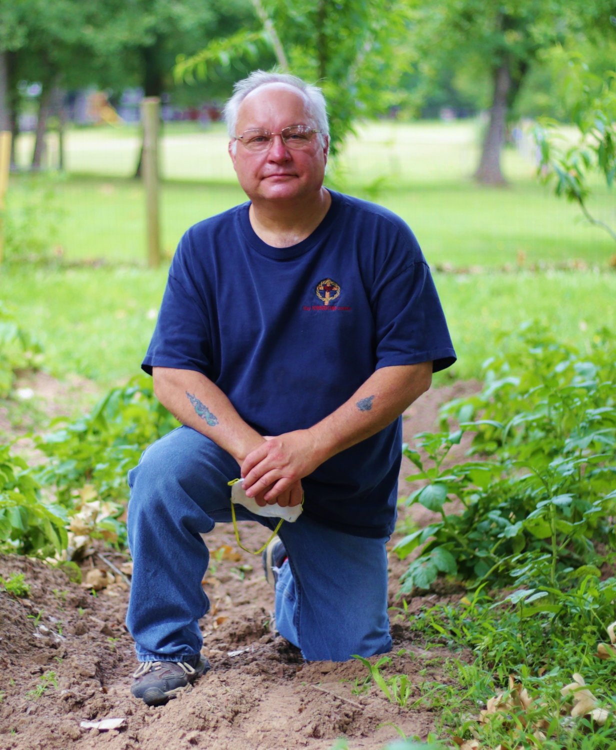 Native gardener Mitchel Bowles among his healthy potato plants.